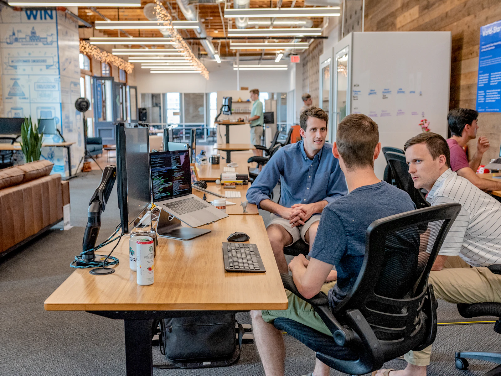 A small team collaborating in a bright modern workspace